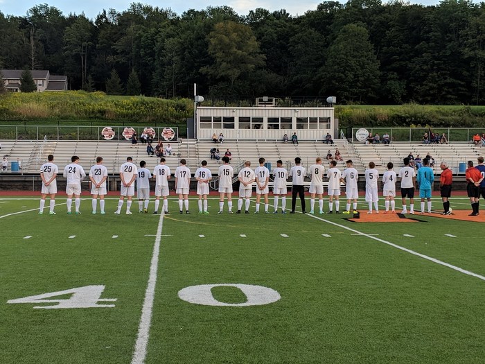 Boys' Varsity Soccer Team facing away from camera to show jersey numbers